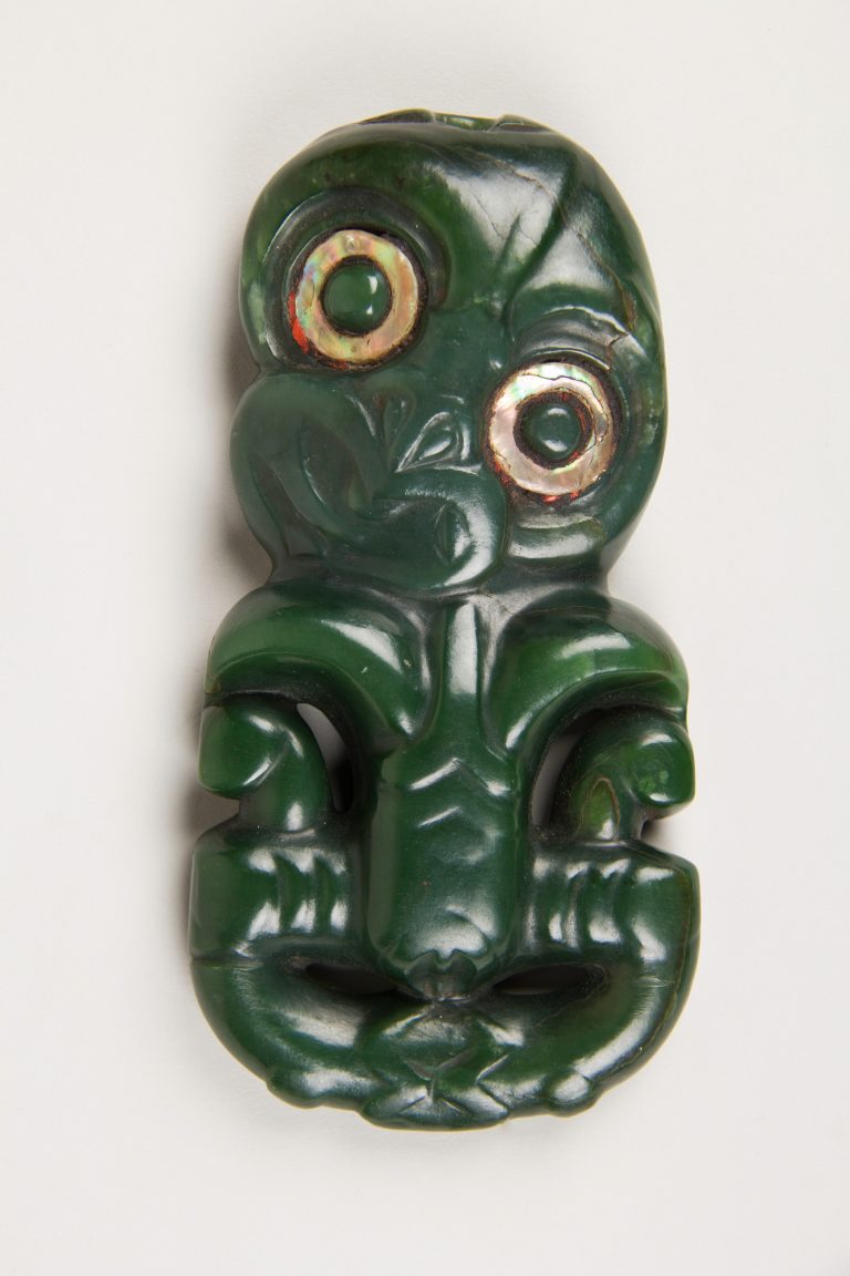 Figure 9:2. Hei tiki, nineteenth century, pounamu (nephrite jade with abalone inlay), 15.5 x 7.6 cm, The Metropolitan Museum of Art, New York City.  Hei tiki pendants were often worn in honour and acknowledgement of figures of one’s whakapapa, or ancestral lineage.
